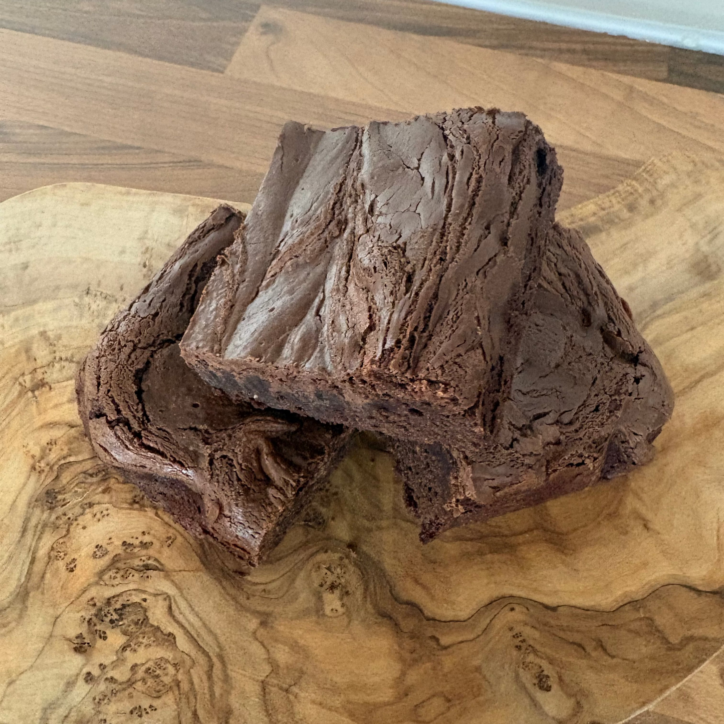Chocolate cake on a wooden cutting board