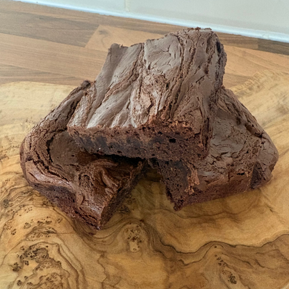 Two Nutella chocolate brownies on a wooden surface